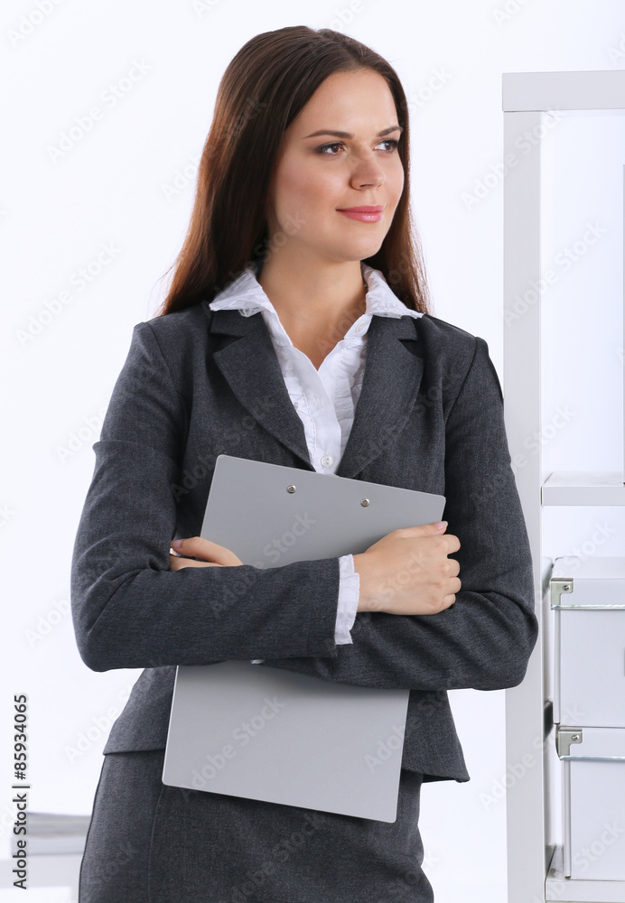 Young business woman standing in office Young business woman standing in office