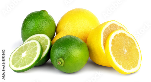 Whole and sliced limes and lemons isolated on white background.