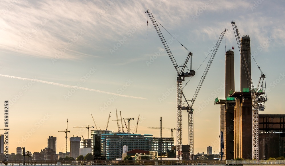 Cranes constructing buildings in London at dawn