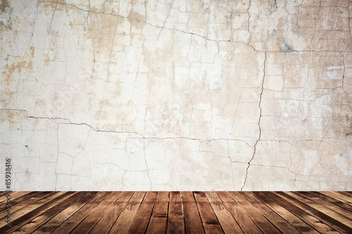 Empty room of grunge wall and wood floor