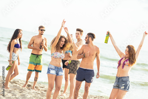 Multiracial group of friends having a party on the beach