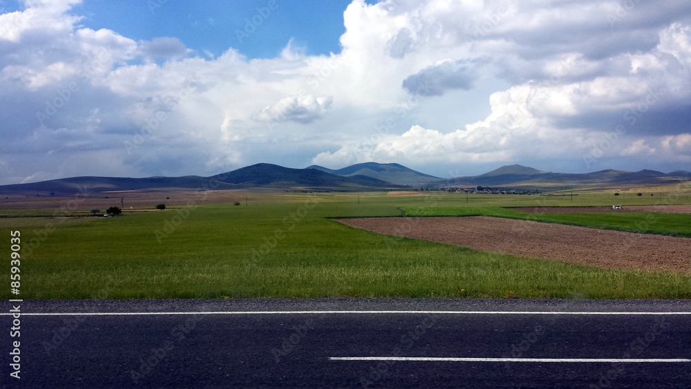 View of the road, fields and mountains
