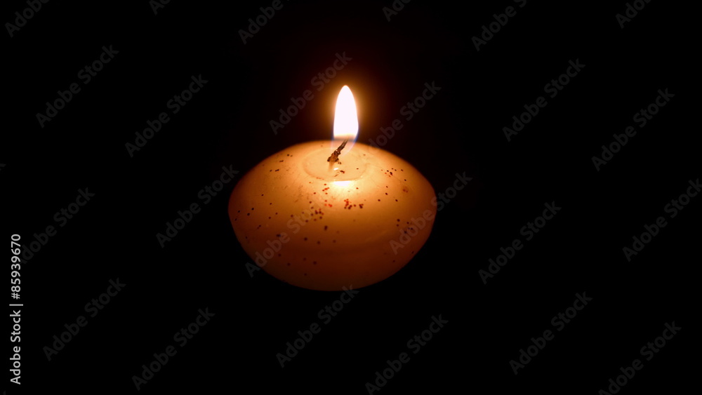 Small candle against dark background Small candle against dark background