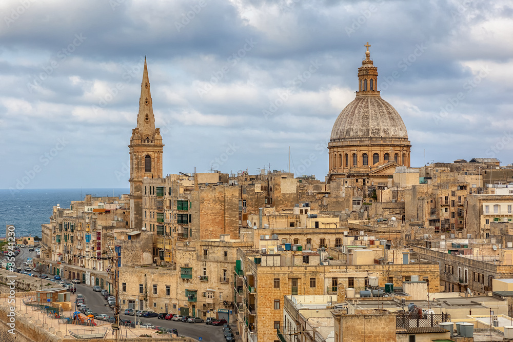 View to Valetta city buildings under clouds