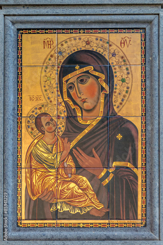 Virgin Mary with child Jesus byzantine style hodegetria icon painted on tiles, on the wall on the street.