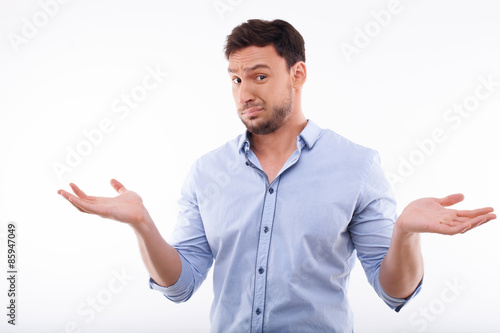 Attractive young man is sorry for knowing nothing