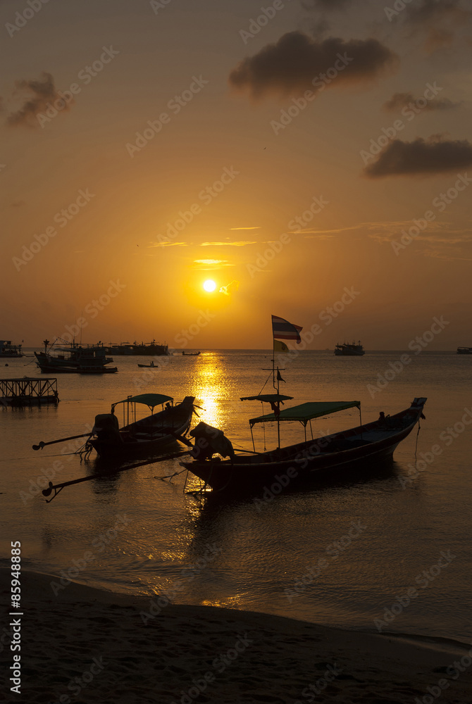 Traditional thai wooden boats at sunset (sunrise) beach.