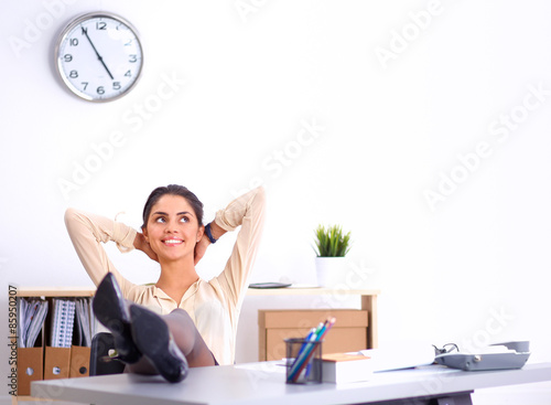 Business woman relaxing with hands behind her head and sitting