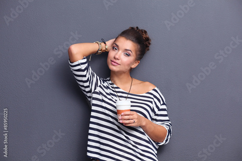 Portrait of young woman with cup tea or coffee