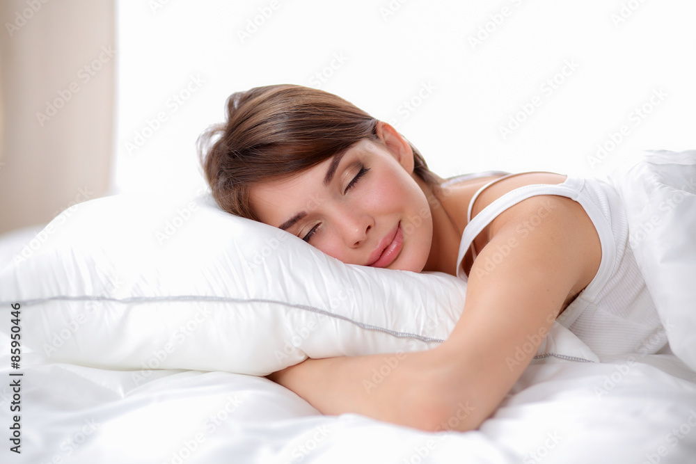 Beautiful girl sleeps in the bedroom, lying on bed Beautiful girl sleeps in the bedroom, lying on bed