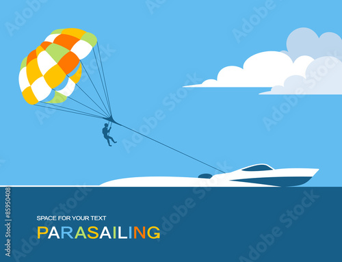Man parasailing with parachute behind the motor boat photo