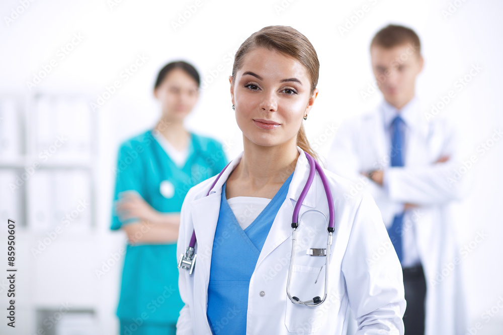 Attractive female doctor in front of medical group Attractive female doctor in front of medical group