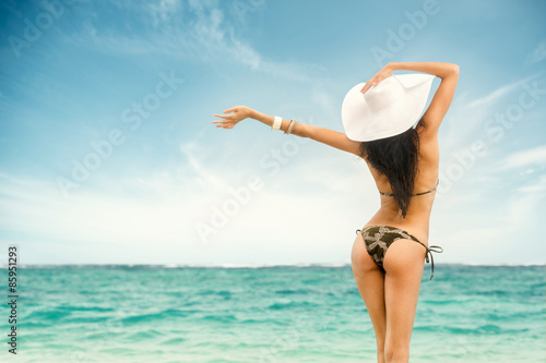 Woman in swimsuit and hat at sea