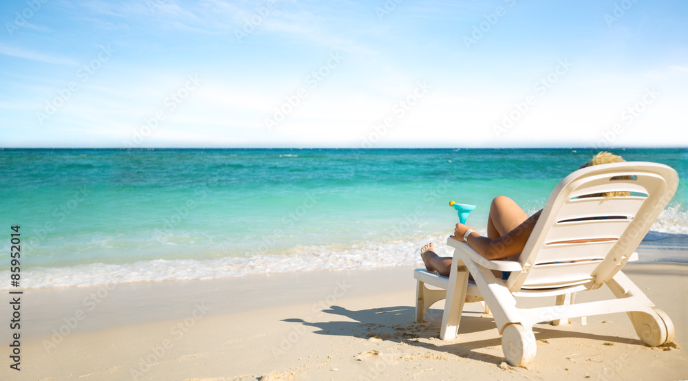 Luxury female sunbathing on the beach