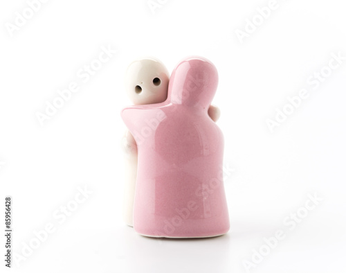 Salt and Pepper Shaker in hug on White photo