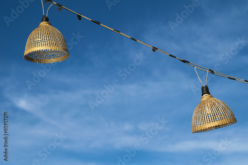 bamboo lamp with sky background at thasadej market nongkhai thailand photo