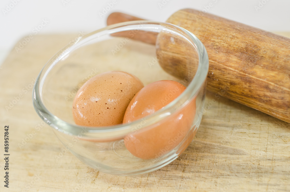 eggs in glass bolw on wooden board eggs in glass bolw on wooden board