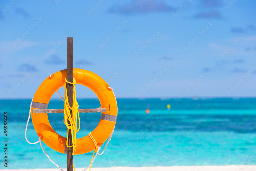 Lifebuoy ring on tropical white beach 