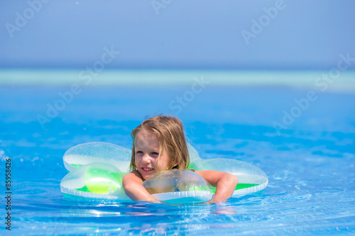 Little happy adorable girl in outdoor swimming pool © travnikovstudio