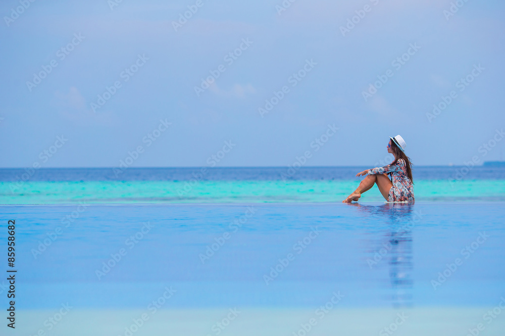 Beautiful young girl relaxing in outdoor swimming pool Beautiful young girl relaxing in outdoor swimming pool