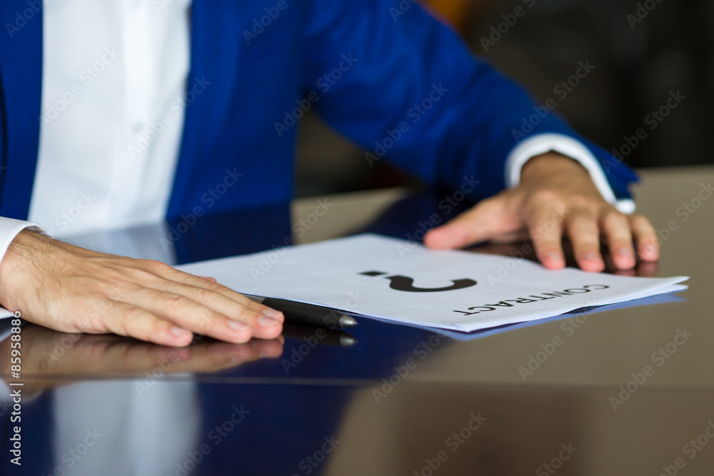 Close up of businessman thinking on a contract paper Close up of businessman thinking on a contract paper