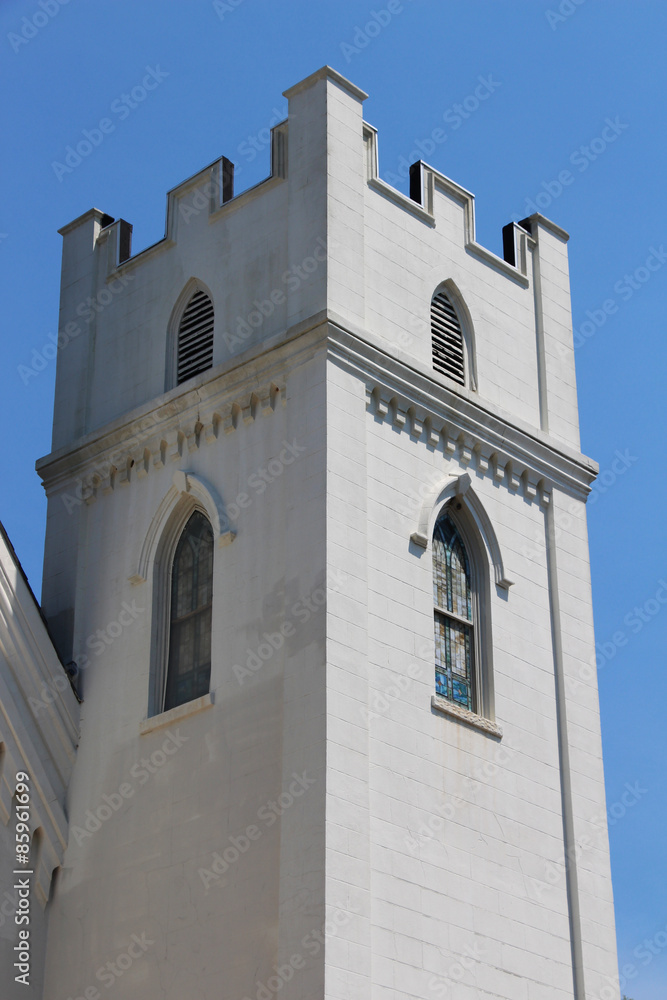 Medieval white tower built in the Gothic style with blue sky in the background