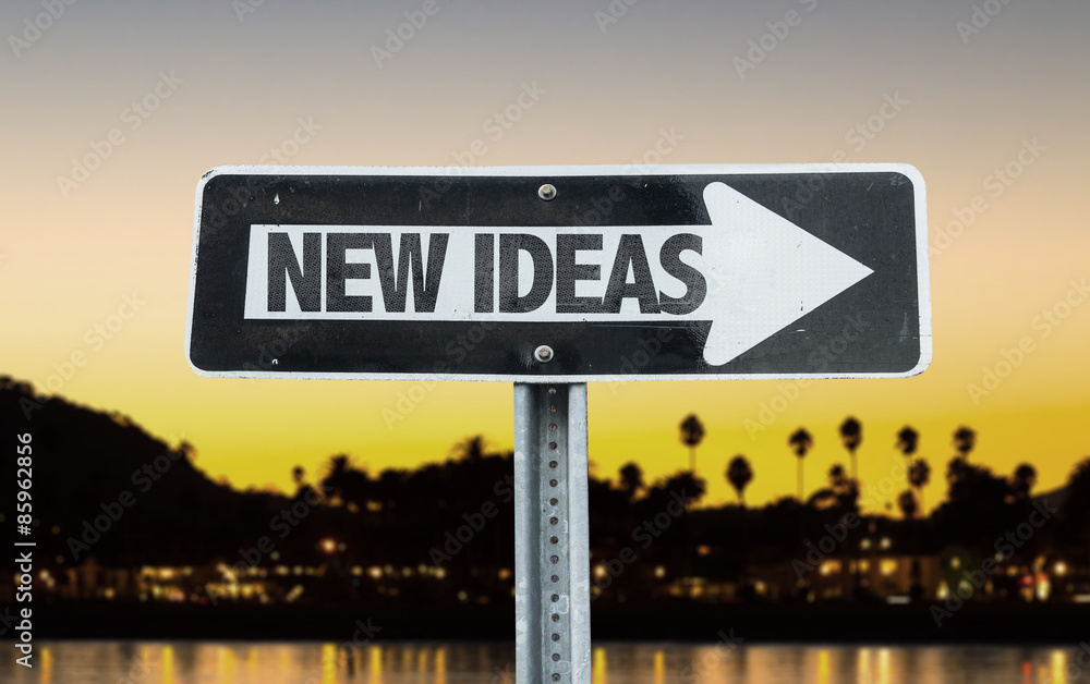 New Ideas direction sign with sunset background
