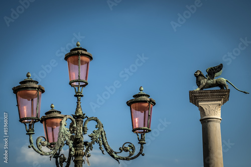 Lamppost in Venice with the Saint Mark's lion in the background © Victor Moussa