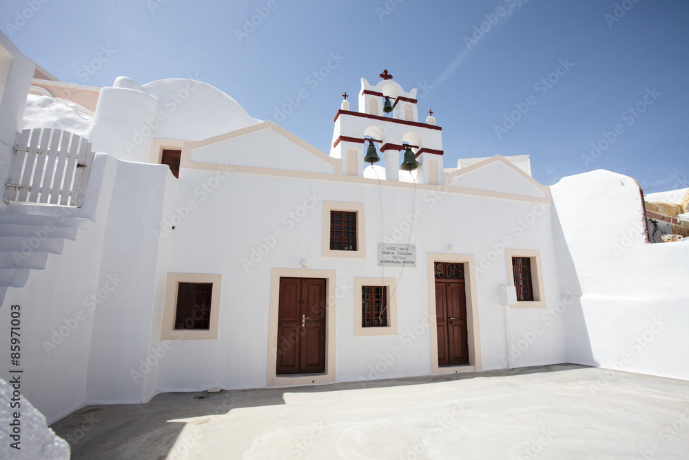 Facade of a white Greek Orthodox church in Oia (Ia), Santorini island, Cyclades Greece