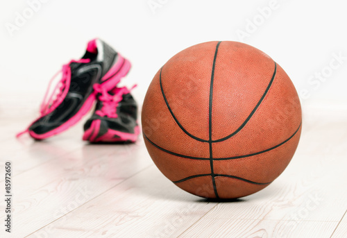 Ball and sneakers for basket