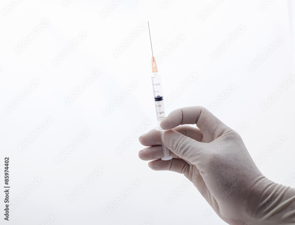 syringe closeup on green background syringe closeup on green background