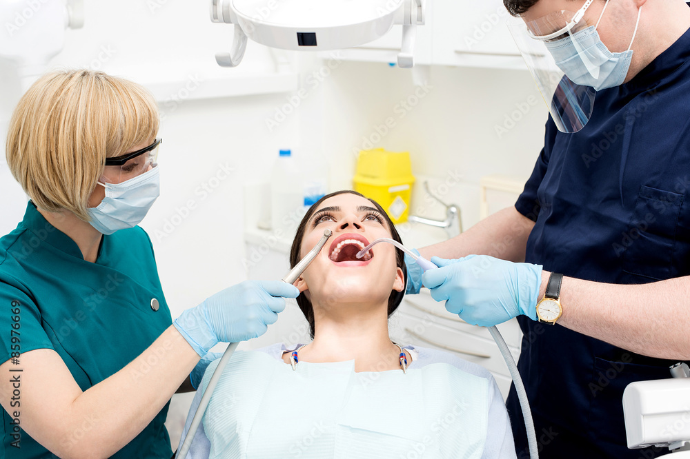Dental cleaning, woman under treatment. Dental cleaning, woman under treatment.