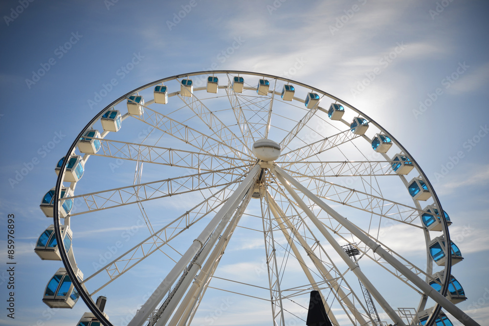 Ferris wheel under blue dramatic skies Ferris wheel under blue dramatic skies