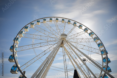 Ferris wheel under blue dramatic skies