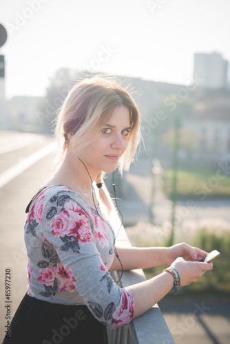 Free Download young beautiful blonde woman outdoor listening music - GFXLoad