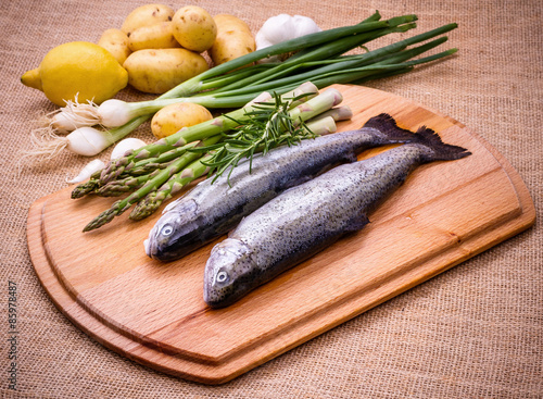Raw trout with green asparagus, lemon and ingredients