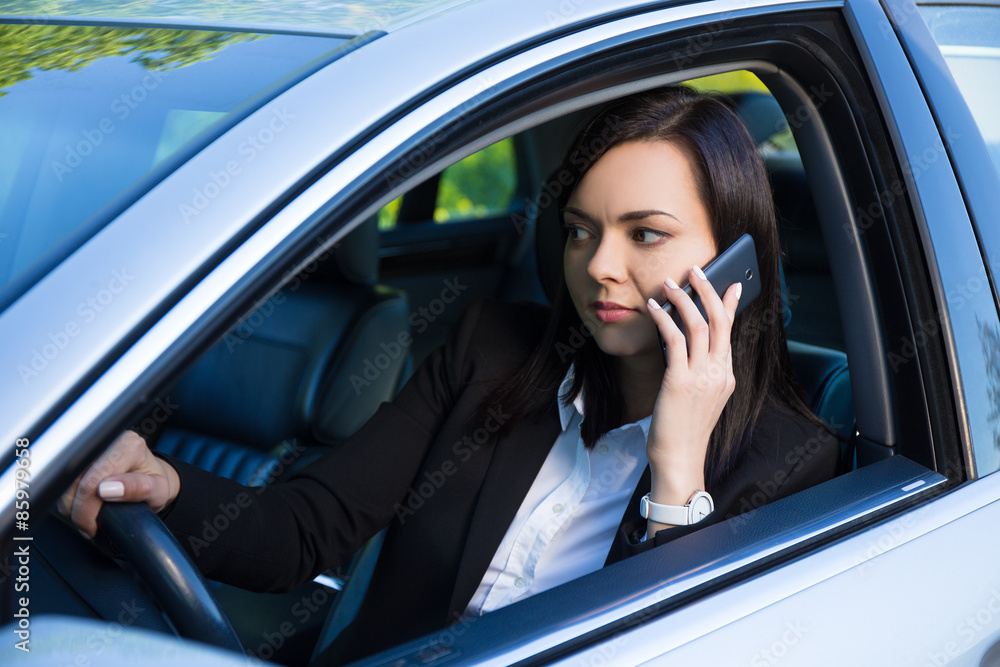 successful business woman talking on smartphone in her car successful business woman talking on smartphone in her car