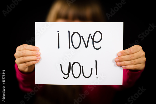 Child holding I Love You sign