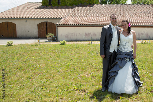 Newlywed couple in  after their wedding looking at the camera photo