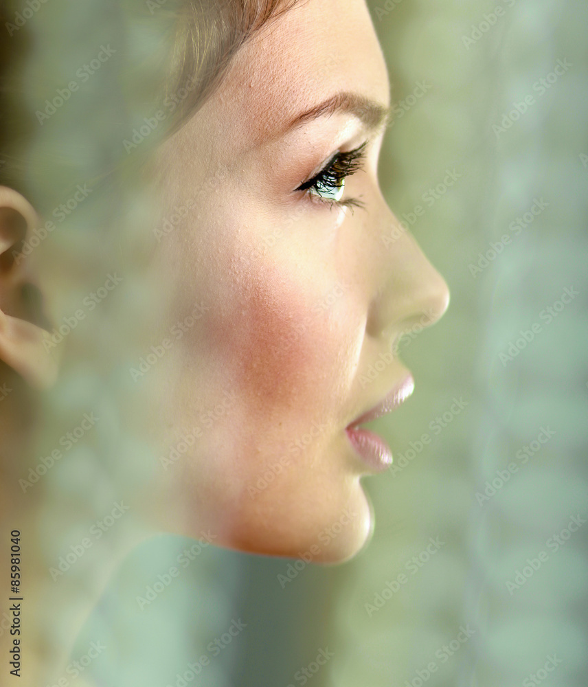 A beautiful woman, portrait isolated on grey background A beautiful woman, portrait isolated on grey background
