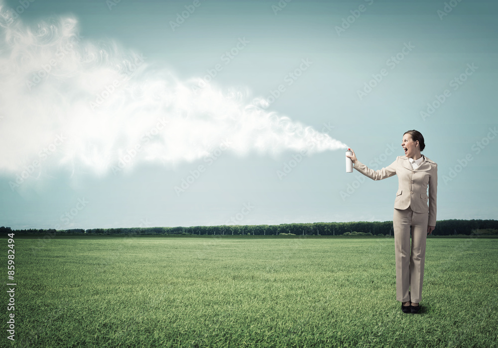 Young businesswoman with suitcase using spray Young businesswoman with suitcase using spray