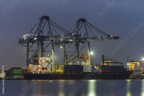 Container Cargo freight ship with working Export at twilight
