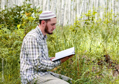 A young man praying outdoors