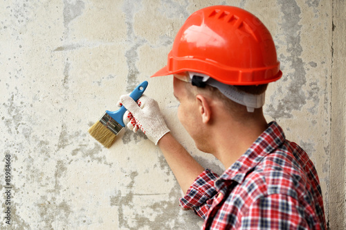 Portrait of a builder in red helmet