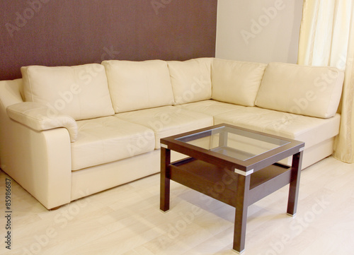White corner leather sofa and coffee table.