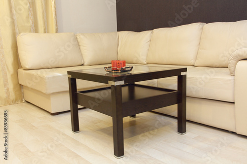 Comfortable white corner leather sofa and coffee table.