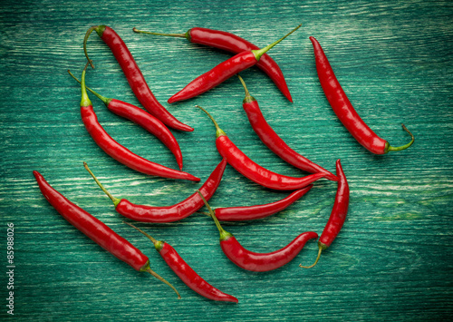 Red hot chili peppers on wooden background