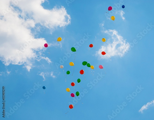 Colored bright balloons flying in the sky