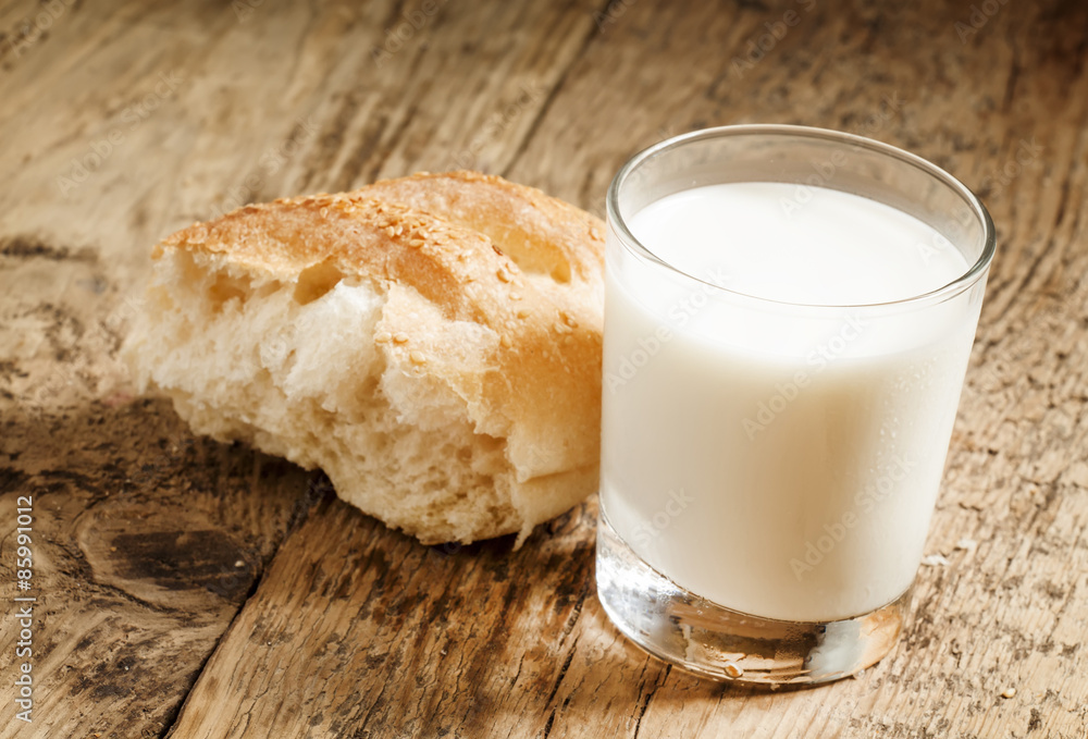 Fresh milk and white bread, selective focus Fresh milk and white bread, selective focus
