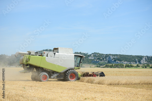 combine harvester agriculture machine harvesting golden ripe wheat field